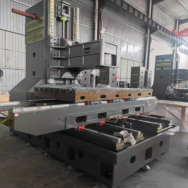 Heavy duty vertical machining center structure showing rigid machine base and column design for stable cutting