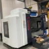 large-cnc-machining-center-installed-workshop-left-view Large CNC machining center installed in workshop showing machine size and industrial installation environment